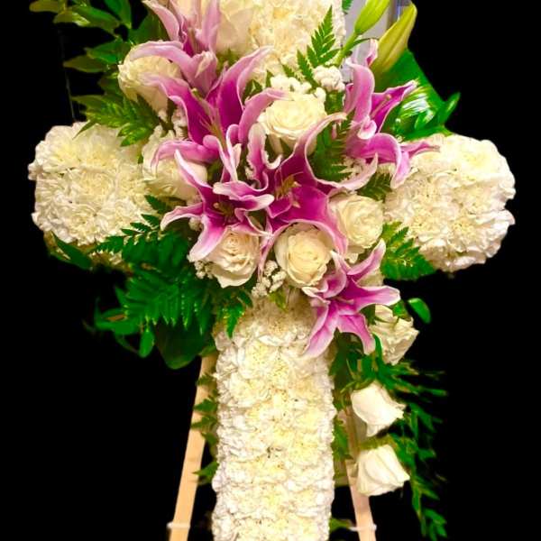 White and pink funeral spray on a wooden easel