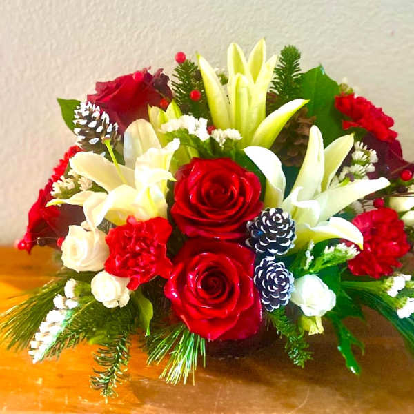 Red and white floral arrangement with lilies and roses