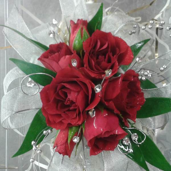 Small bouquet of red roses with silver ribbon and bead accents