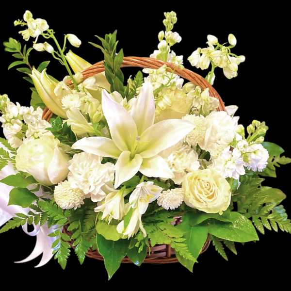 White floral basket arrangement with lilies and roses