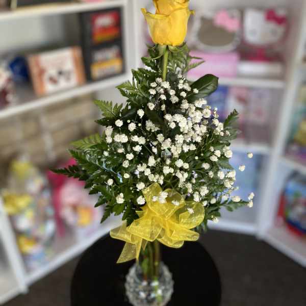 Yellow rose arrangement with baby's breath in a clear vase and yellow ribbon