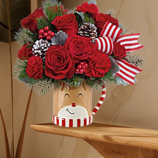 Red roses in a festive holiday container with striped ribbon and pinecones