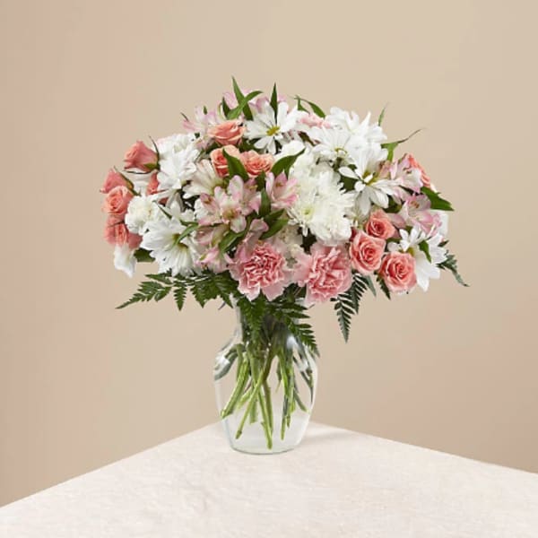 Pink and white mixed bouquet in a clear glass vase