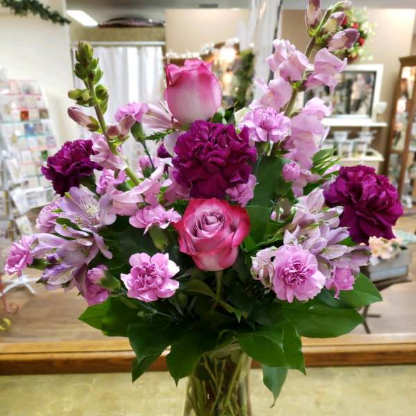 Pink and purple mixed bouquet in a clear glass vase