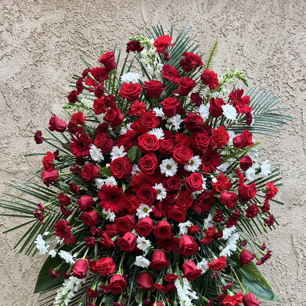 Large standing floral spray with red roses and white daisies