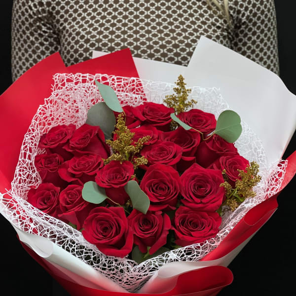 Bouquet of red roses wrapped in red and white paper