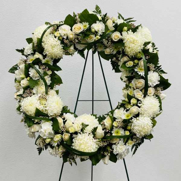 White floral wreath on a standing easel