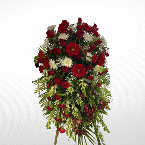 Large standing spray of red and white flowers on a support stand