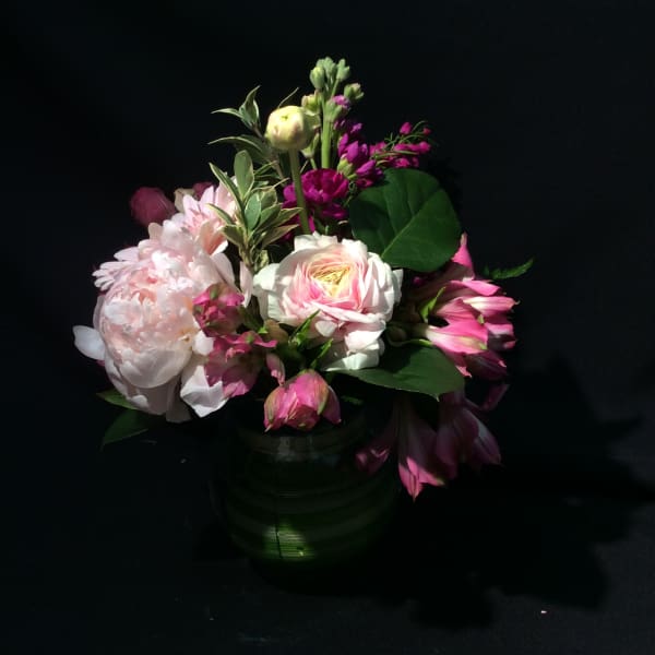 Pink and white mixed flower arrangement in a glass vase