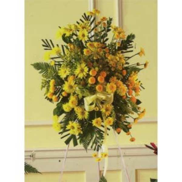 Tall yellow and orange floral standing spray on an easel