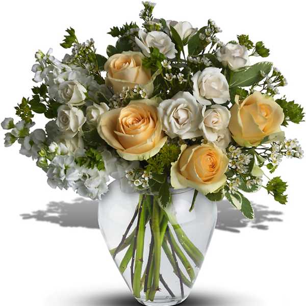 Bouquet of cream and white roses in a clear glass vase