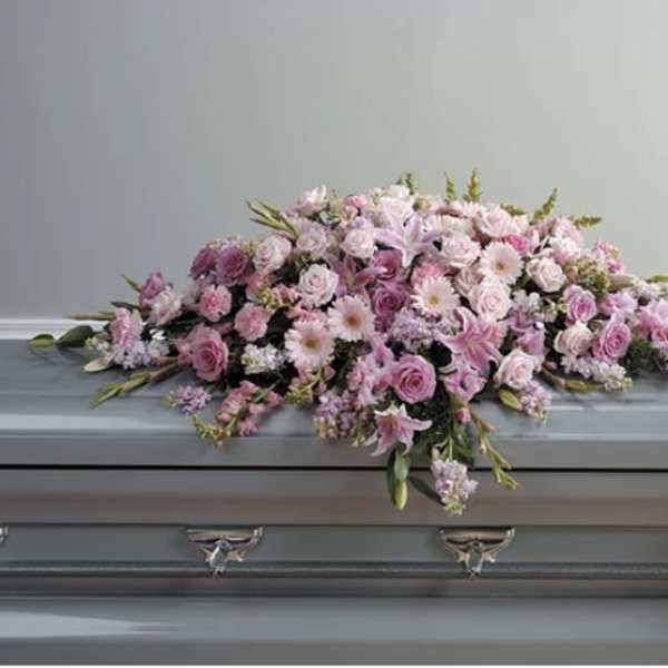 Pink floral casket spray with roses and lilies