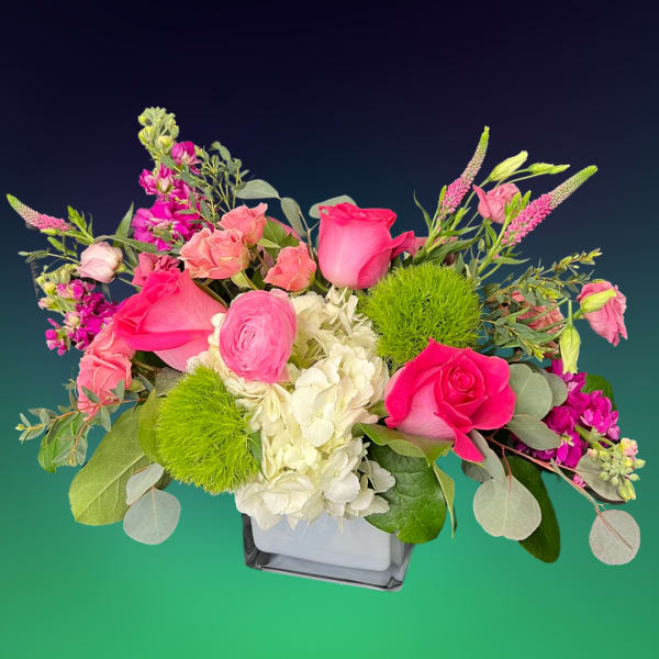 Pink roses and white hydrangea in a square glass vase