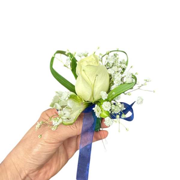 White rose boutonniere with baby's breath and blue ribbon