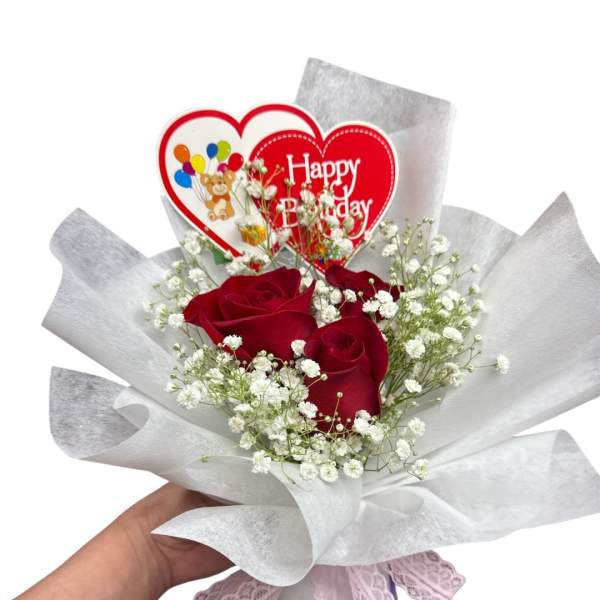 Red roses with baby's breath and a Happy Birthday heart topper