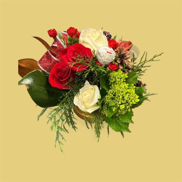 Bouquet of red and white roses with greenery and a candy accent