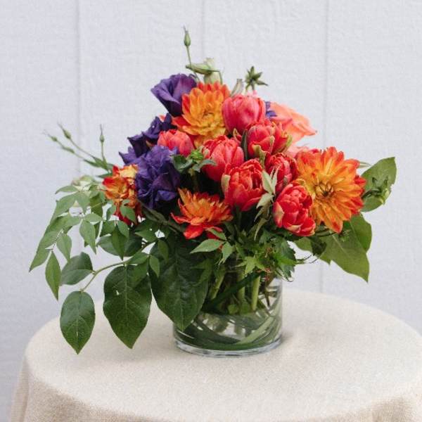 Colorful bouquet of mixed flowers in a clear glass vase