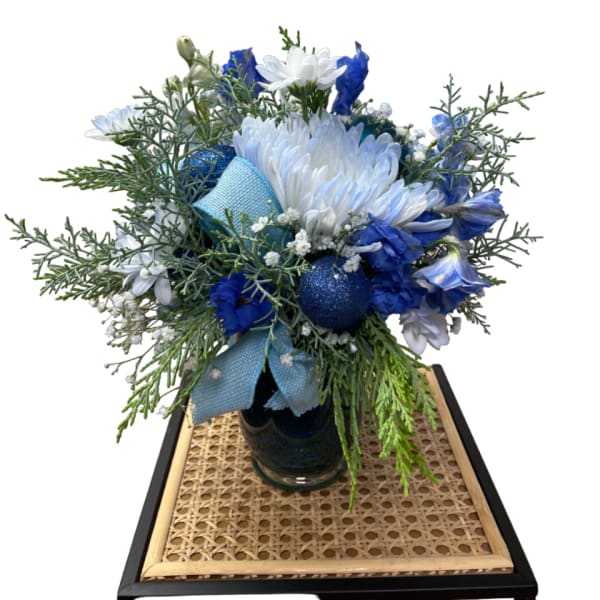 Blue and white bouquet in a glass vase with a ribbon