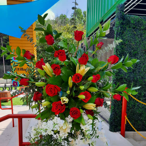 Tall standing floral spray with red roses, white blooms, and lilies