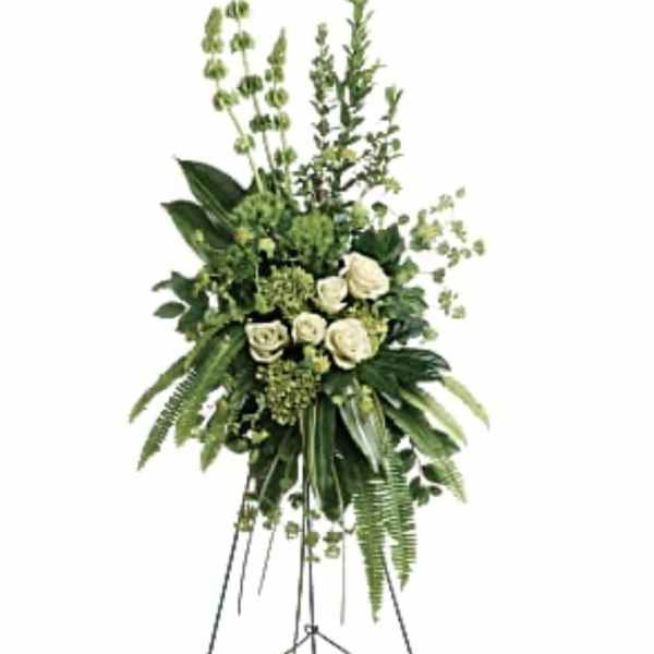 Tall white rose and greenery standing spray on an easel