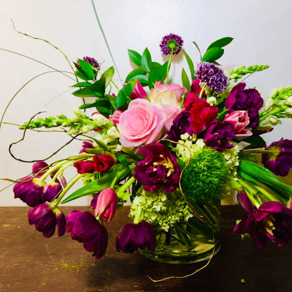 Bouquet of pink and purple flowers in a glass vase