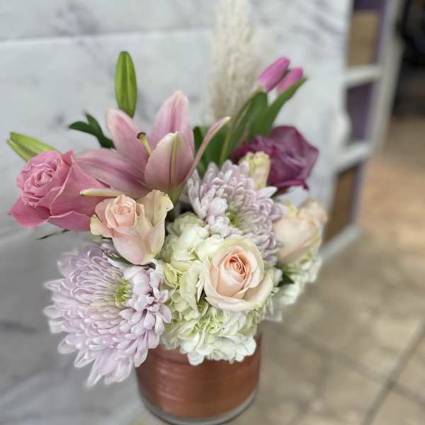 Pink and white bouquet in a copper-toned vase