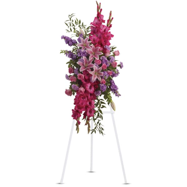 Tall pink and purple floral spray on a white easel