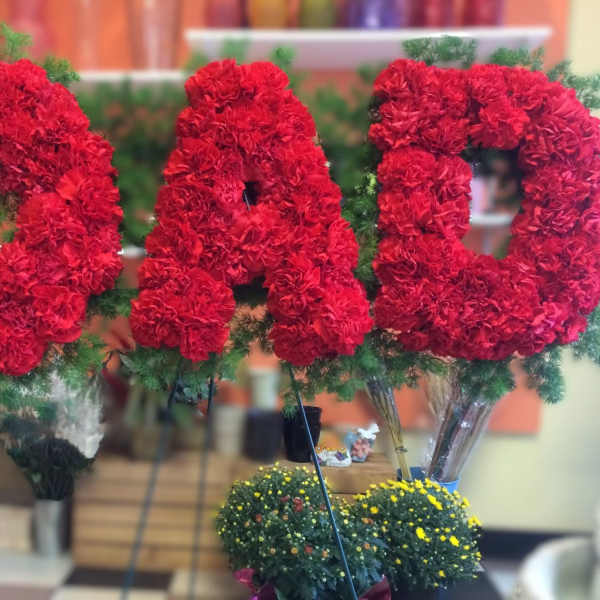 Large red floral letters spelling DAD with greenery accents