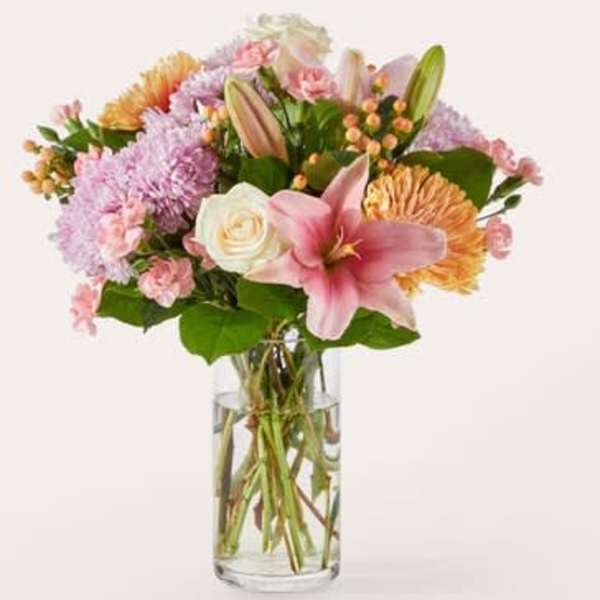 Pink and peach mixed bouquet in a clear glass vase