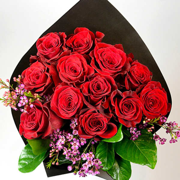 Bouquet of red roses with small pink filler flowers