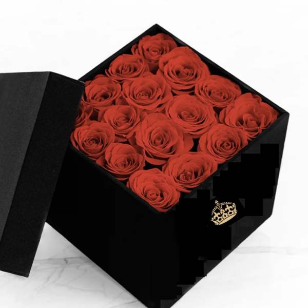 Black gift box filled with red roses