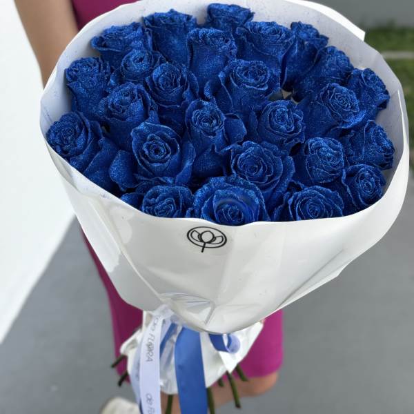 Bouquet of glittery blue roses wrapped in white paper