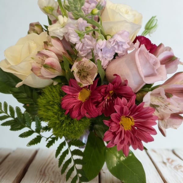 Mixed bouquet of pale roses, pink daisies, and alstroemeria