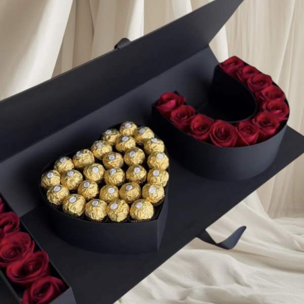 Heart-shaped box of red roses and gold-wrapped chocolates
