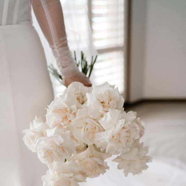 Bride holding a bouquet of white roses