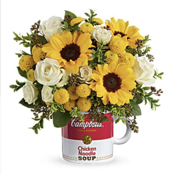 Sunflower and white rose bouquet in a Campbell's soup mug