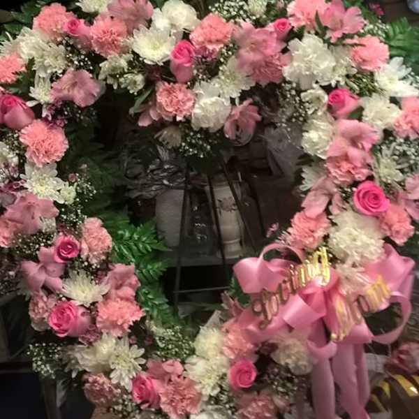 Pink and white floral wreaths with ribbon bows