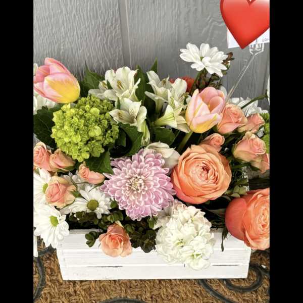 Mixed bouquet in a white box with pink roses, tulips, and white daisies
