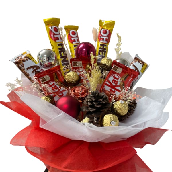 Candy bouquet with KitKat bars, Ferrero Rocher chocolates, and pinecones in red and white wrap