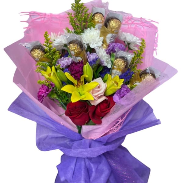 Bouquet of mixed flowers with chocolate truffles wrapped in purple tissue