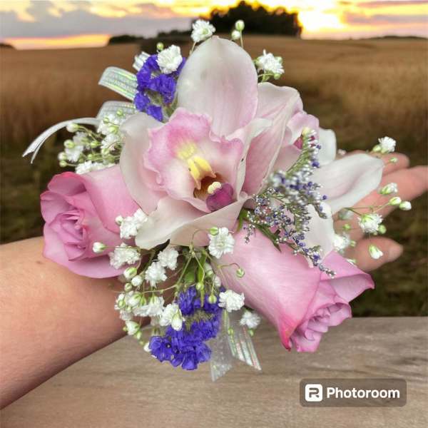 Small pink and white floral wrist corsage with ribbon