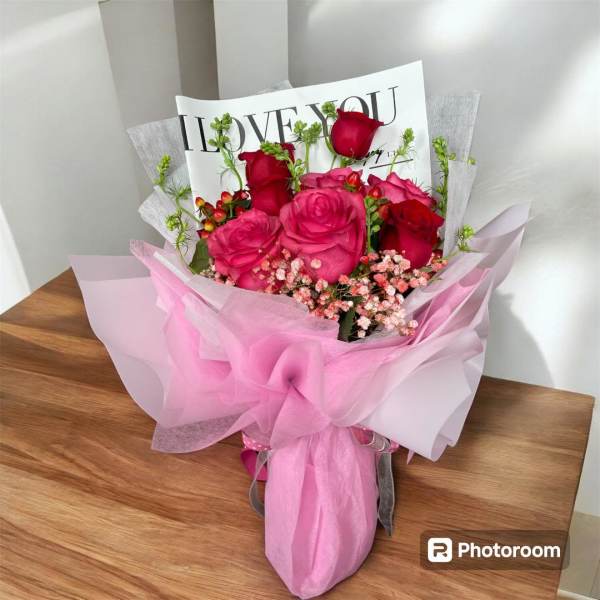 Pink and red rose bouquet wrapped in pink paper