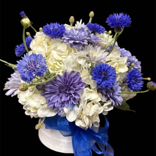 Blue and white bouquet in a white hat box with a blue ribbon
