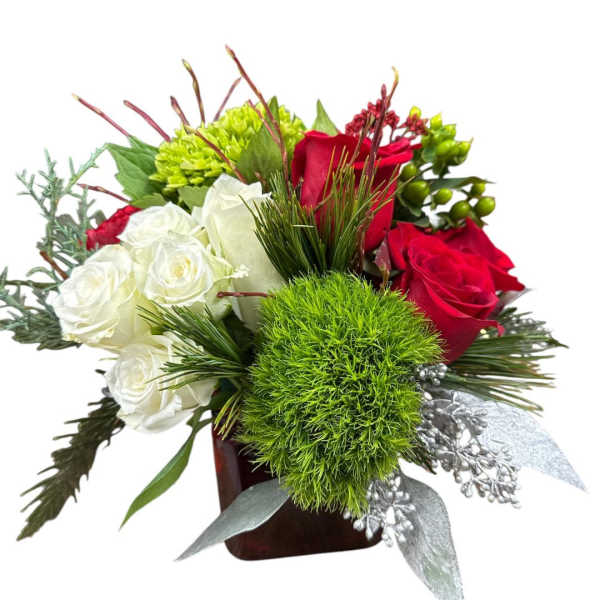 Red and white roses with green accents in a square vase