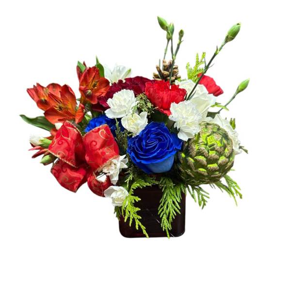 Mixed bouquet with red, white, and blue flowers in a dark vase