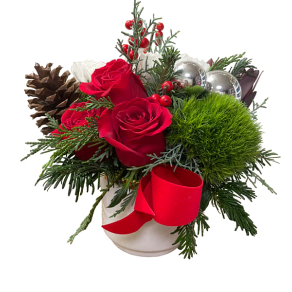 Red roses in a white vase with pinecones and a red ribbon
