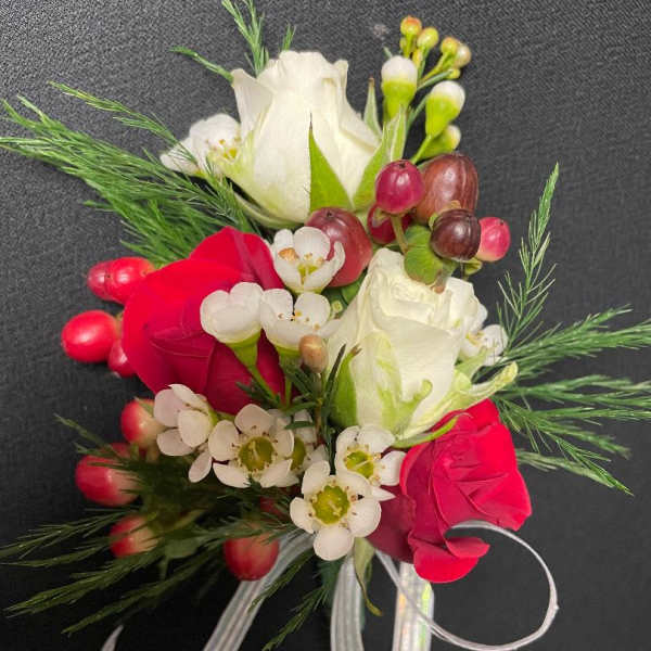 Small bouquet of red and white roses with white filler flowers