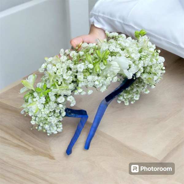 White floral crown with blue ribbon ties