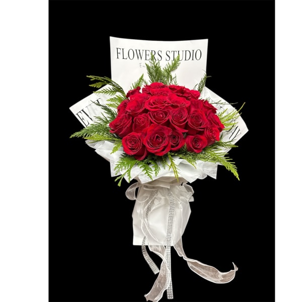 Bouquet of red roses with white wrapping and ribbon