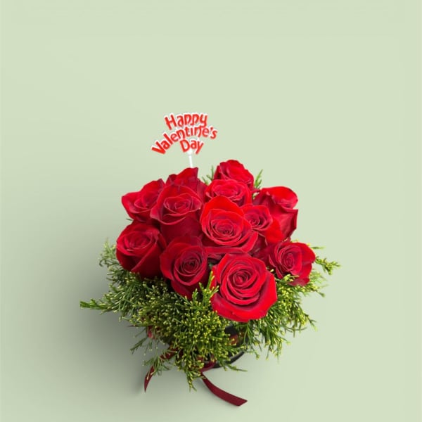 Bouquet of red roses with a Valentine's Day topper